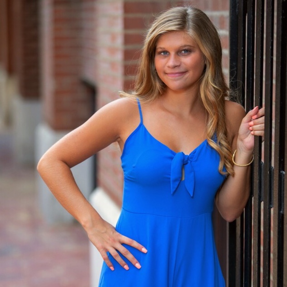 Blue romper with ruffle edging and a bow tie